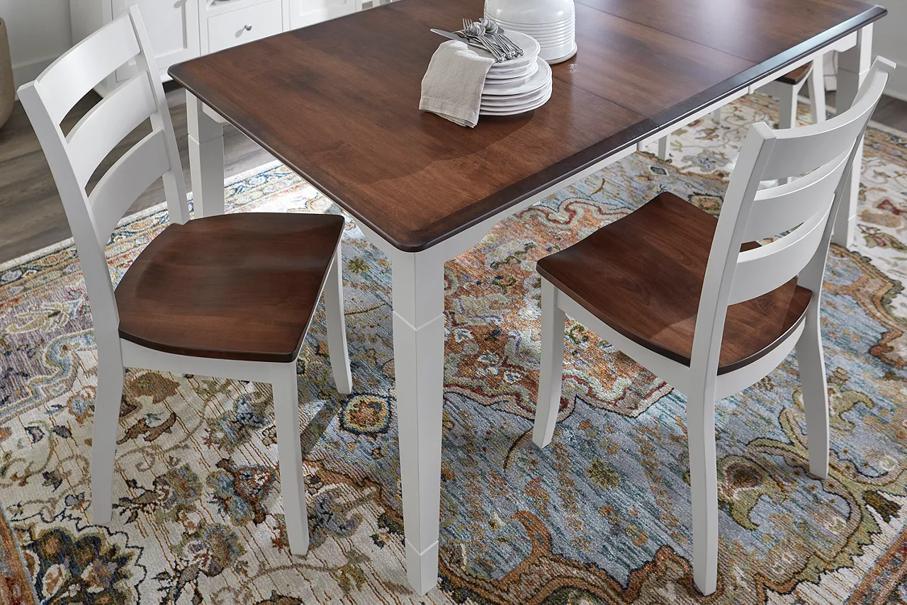 Detail of two-tone maple wood Memphis dining table and ladderback chair